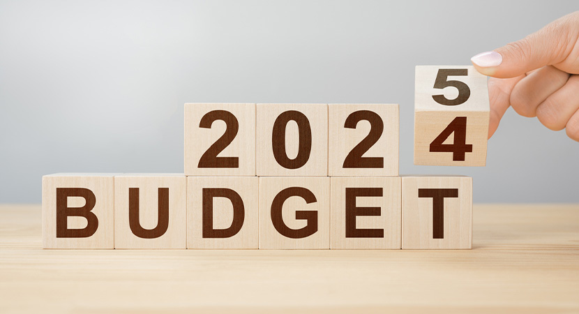 Wooden blocks that spell out "2024 BUDGET" with the last block being changed to "5"