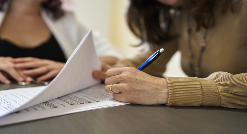 Woman Signing Lease Renewal Document